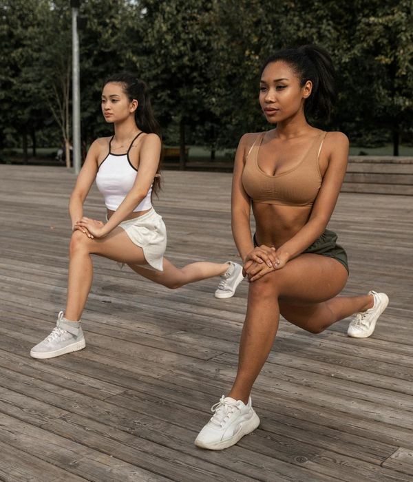 Woman in a calm, seated yoga pose, embodying physical and mental balance.